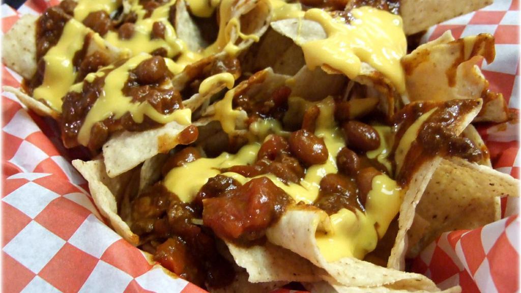 Lucy & Ricky Chili-Cheese Nachos · Tortilla chips smothered in meat and bean chili, topped with cheddar cheese, sour cream, jalapeños and tomato aioli.