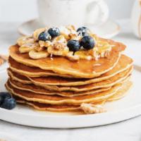 Berry Nut Pancakes · 3 buttermilk pancakes loaded with blueberries and walnuts.