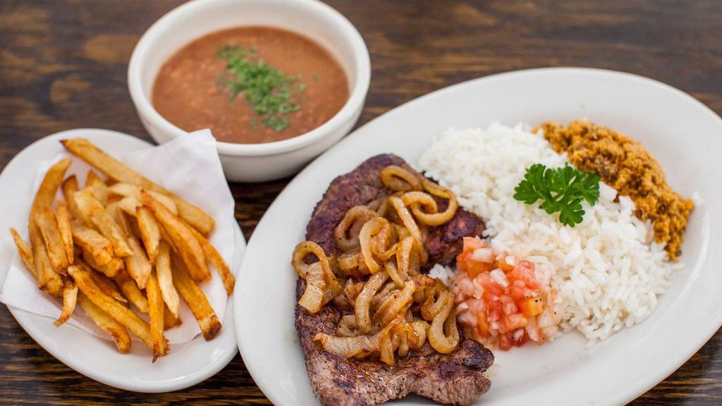 Bife Acebolado · Thin pan fried grassfed steak with onions served with white rice, beans, farofa, country vinaigrette sauce and fries