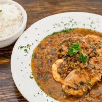 Xinxim De Galinha · Bahia's organic chicken and shrimp stew with tomatoes, cilantro and onions served with white...