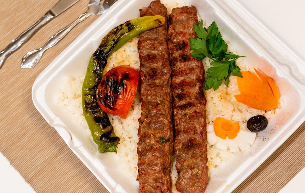Adana Kebab · Ground lamb and beef meat. Served with mixed onion and parsley as a garniture, and rice or bulgur.