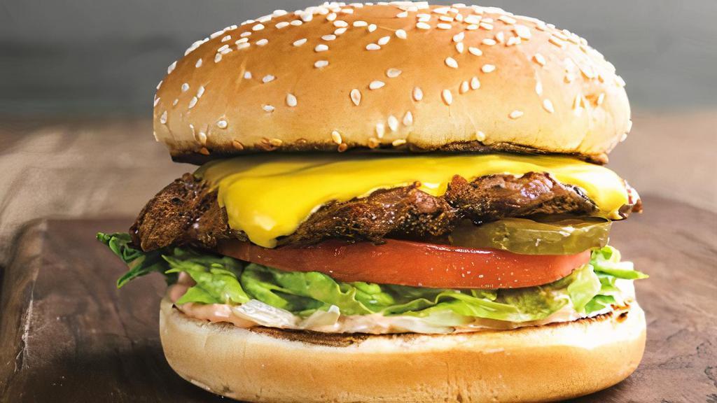 Cheese Burger · Scrumptious, 100% beef patty with zero additives or preservatives, seasoned with pepper and salt, and topped with a slice of cheese, lettuce, tomato, onion, pickles, and a condiment of your choice on a freshly baked bun.
