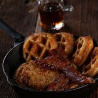 The Early Bird · Fried chicken & waffles topped with bacon, honey butter & maple syrup.