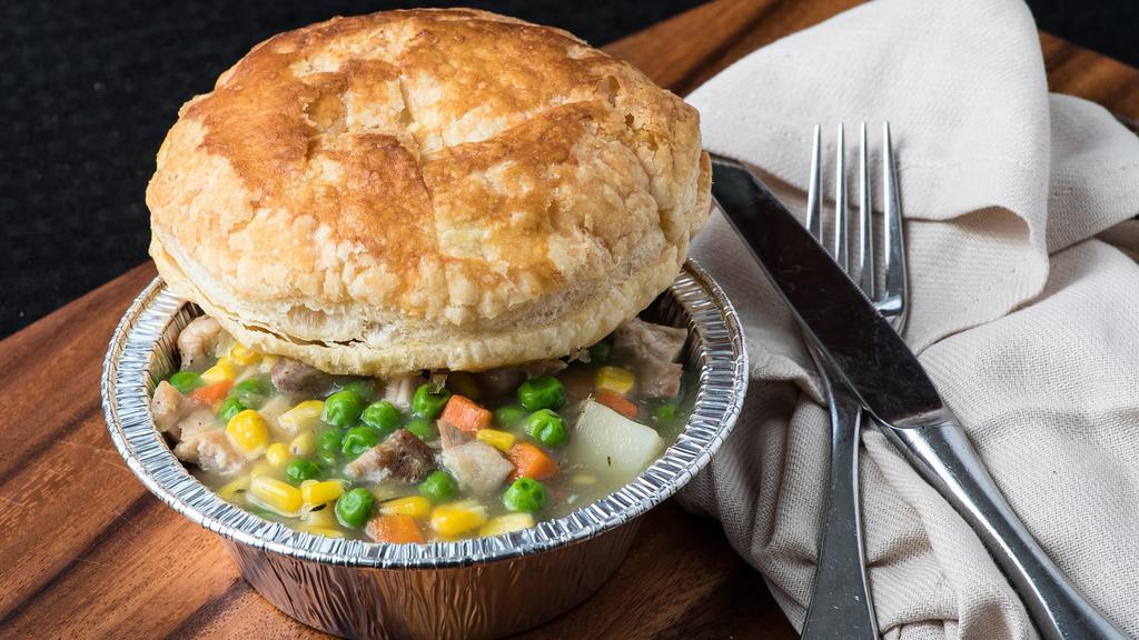 Chicken Pot Pie · Personal Sized, made with Slow Roasted Chicken, Peas, Carrots, Potatoes and a Rich and Creamy Sauce, Topped with a Buttery & Flakey Puff Pastry. Served with your Choice of Side.