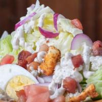 Wedge Salad · Large Wedge of Iceberg Lettuce topped with our Creamy Homemade Blue Cheese dressing, Shaved ...
