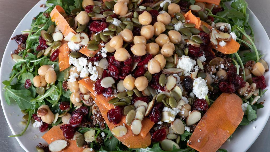 Chickpea Salad · Baby Arugula tossed with Chickpeas, Quinoa, and Carrots. Topped with Feta Cheese, Dried Cranberries, Almonds, and Pumpkin Seeds. Served with a Cinnamon Chili Vinaigrette.
