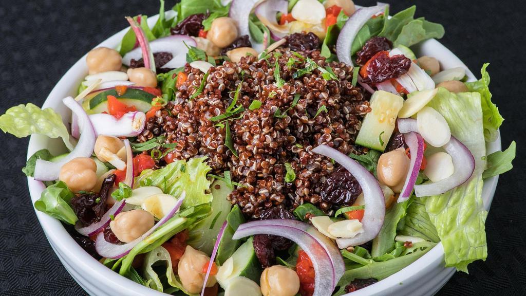 Quinoa Salad · Blend of Spinach, Iceberg, & Romaine topped with Quinoa, Garbanzo Beans, Diced Cucumber, Roasted Red Pepper, Shaved Red Onion, and Toasted Almond Slivers. Finished with Dried Cranberries and our Lemon Garlic Vinaigrette.
