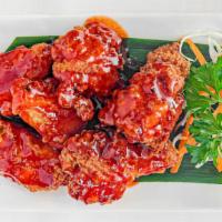 Fried Chickenwings · Fried chicken wings mixed with spicy house sauce.