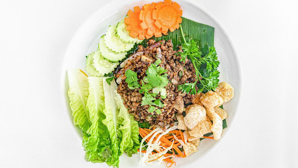 Larb Salad · Ground chicken or ground pork with mints, cilantro, tomatoes, onions, roasted rice, chili, lime dressing.