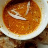 Roti And Massaman Curry · Fried bread with curry sauce.
