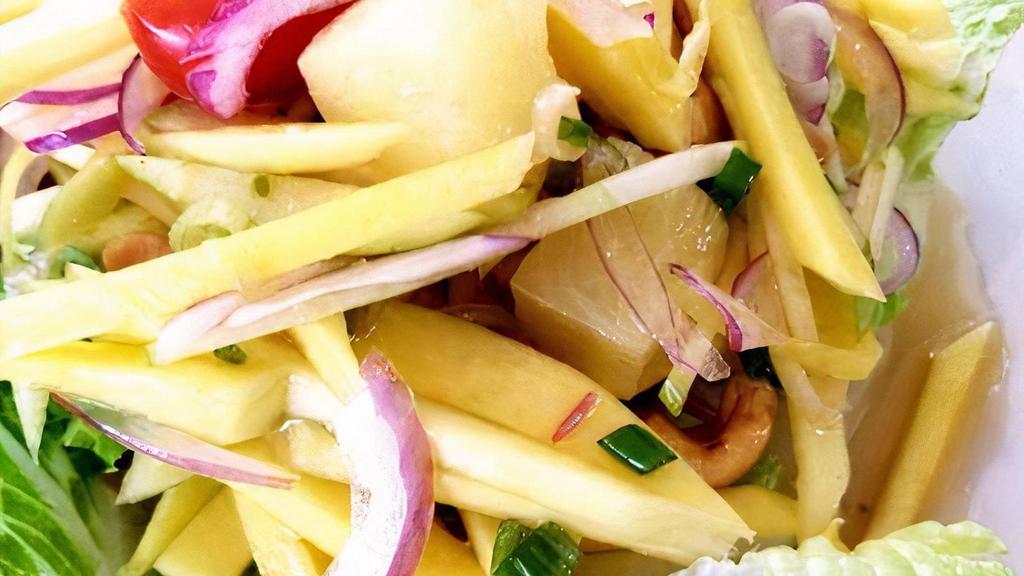 Mango Salad · Shredded mango, pineapple, scallion, red onion, cashews, tomato and apple in chili lime. Hot and spicy.