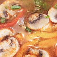 Tom Yum · Hot-sour soup with Shrimp mushrooms, galanga, bell pepper, lemongrass and scallion