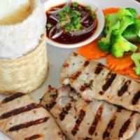 Moo Yang · Thin pork chop marinated with garlic, cilantro and white pepper served with steamed broccoli...