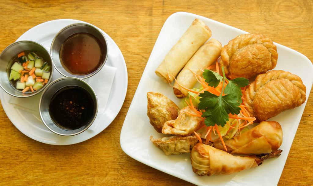 Mixed Appetizer · Two spring rolls, two curry puffs, two veg dumplings, and two shrimp rolls.