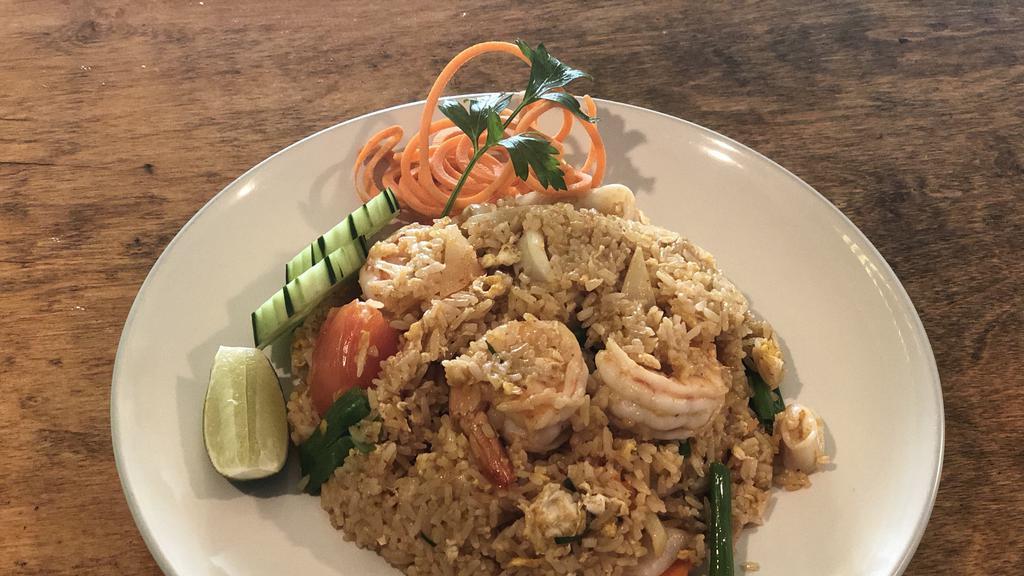 Tom Yum Fried Rice · Spicy fried rice with egg, lemongrass, lime leaves, onion, carrot, tomato, scallion, lime juice.