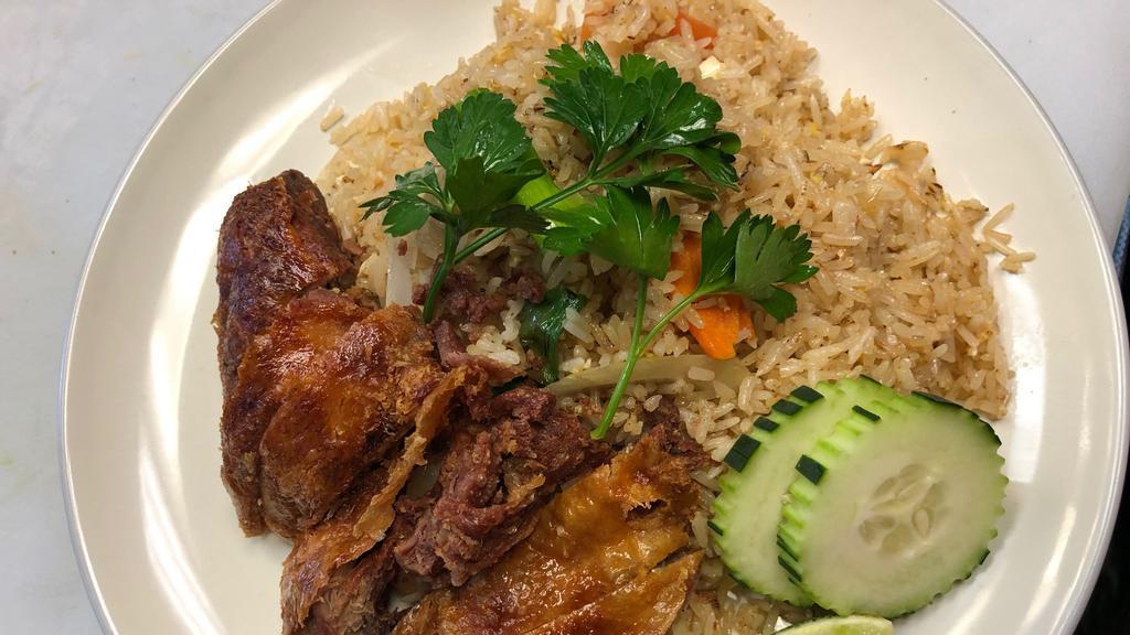 Crispy Duck Fried Rice · Fried rice with egg, onion, carrot, scallion and tomato topped with Crispy Duck.
