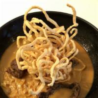 Khao Soy Beef · Egg noodle, red onion, scallion and pickles in spicy northern thai curry. Topped with Crispy...