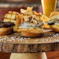 Filet Mignon Sliders · Three sliders served on a Brioche bun with Mozzarella, sautéed onions and french fries.