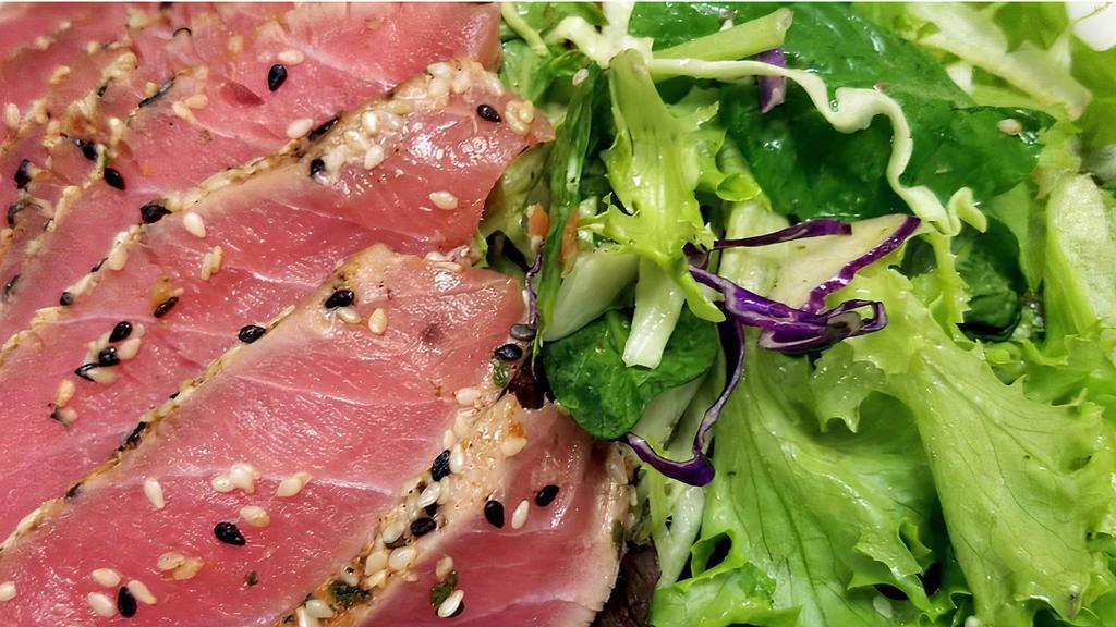 Seared Ahi Salad · Local organic mixed lettuce, shredded, green and purple cabbage, carrots, peppers sesame seeds, Asian dressing and won ton chips.