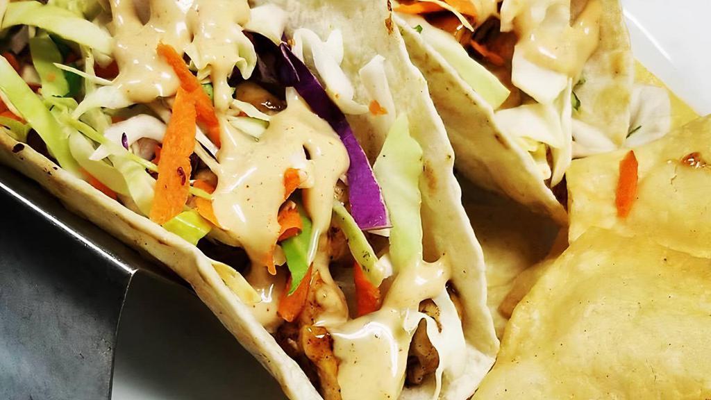 Teriyaki Chicken · Served in flour tortillas with our homemade slaw red onion, cilantro and aioli teriyaki.