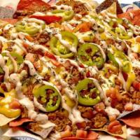 Impossible Nachos · Fresh fried tortilla chips layered with Impossible Chili, Fat Tire beer cheese, & cheddar/mo...
