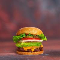 Cado Classic Veggie Burger · Seasoned vegetarian patty topped with avocado, melted cheese, lettuce, tomato, onion, and pi...