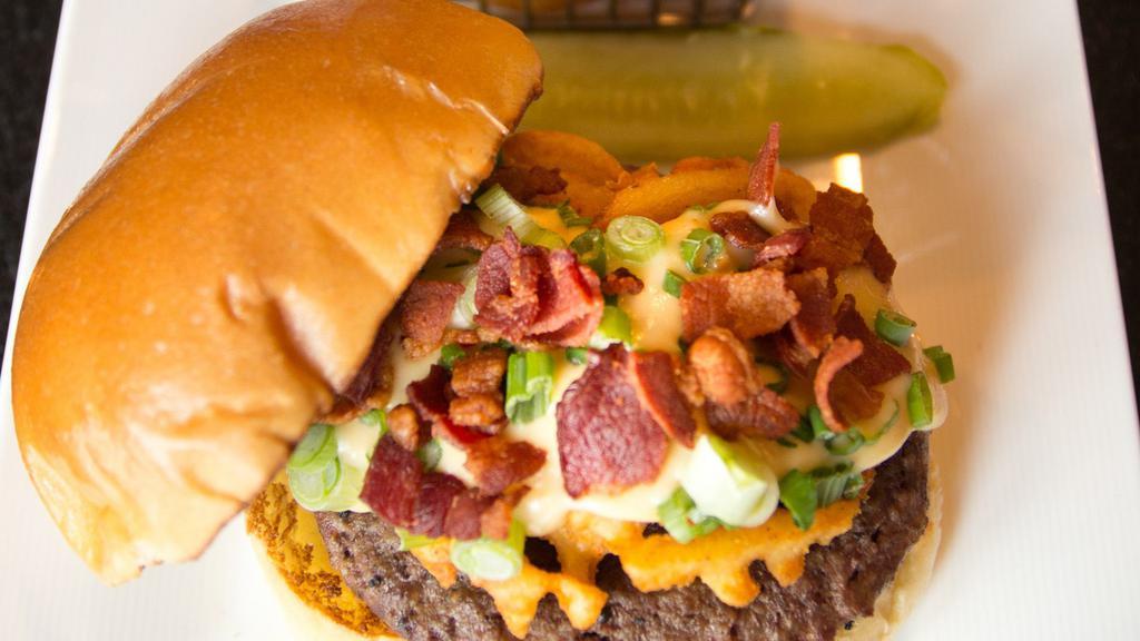 The Villager Burger · signature Angus beef blend, waffle fries, gouda cheese sauce, bacon, scallions. 

Consumption of under-cooked meat, poultry, eggs, or seafood may increase the risk of foodborne illness. Especially if you have certain medical conditions.