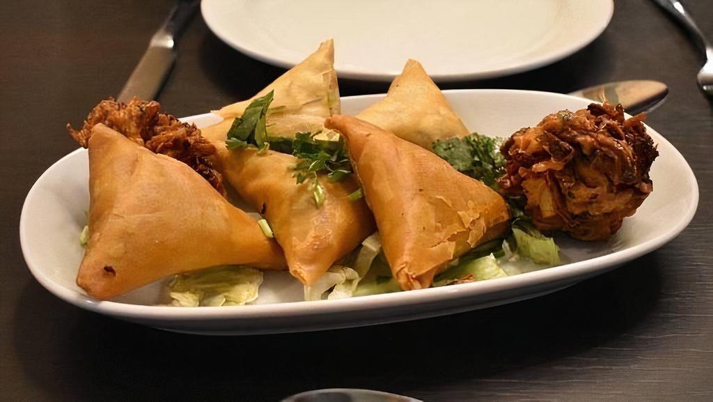 Vegetable Samosa · Crispy turnover, delicious filled with mildly spices potatoes and green peas.
