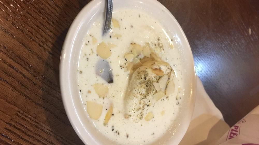 Rasmalai · Soft cheese poached in milk sauce, topped with pistachios.