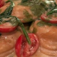 Lobster Ravioli · With baby spinach, grape tomatoes in cream tarragon sauce and a touch of pesto.