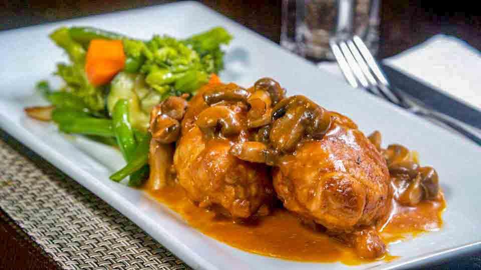 Involtini Di Pollo · Chicken breasts rolled stuffed with prosciutto, Mozzarella cheese, sautéed with mushrooms in port wine sauce served with vegetables (Gluten-Free option also available)