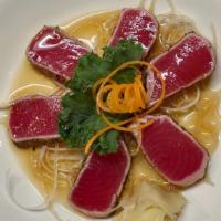 Seared Pepper Tuna · Tuna Tataki ; six pieces of black pepper-coated tuna, lightly seared. Comes with a side of p...