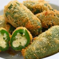 Cheddar Jalapeño Poppers · Jalapenos stuffed with cheese then crisped to perfection.
Served with a side of cool Ranch.