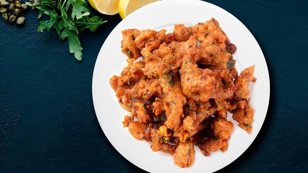 Traditional Onion Pakora · Mouthwatering crisp onions golden fried in a seasoned chickpea batter.