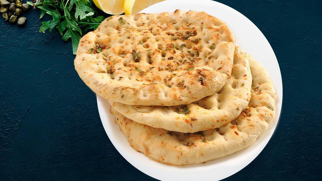 Garlic Naan · Flat bread sprinkled with crushed garlic, cheese and baked in tandoor oven