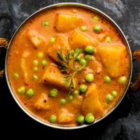 Alu Mutter · Potatoes gently cooked in cream with green peas & spices. Served with Basmati rice.
