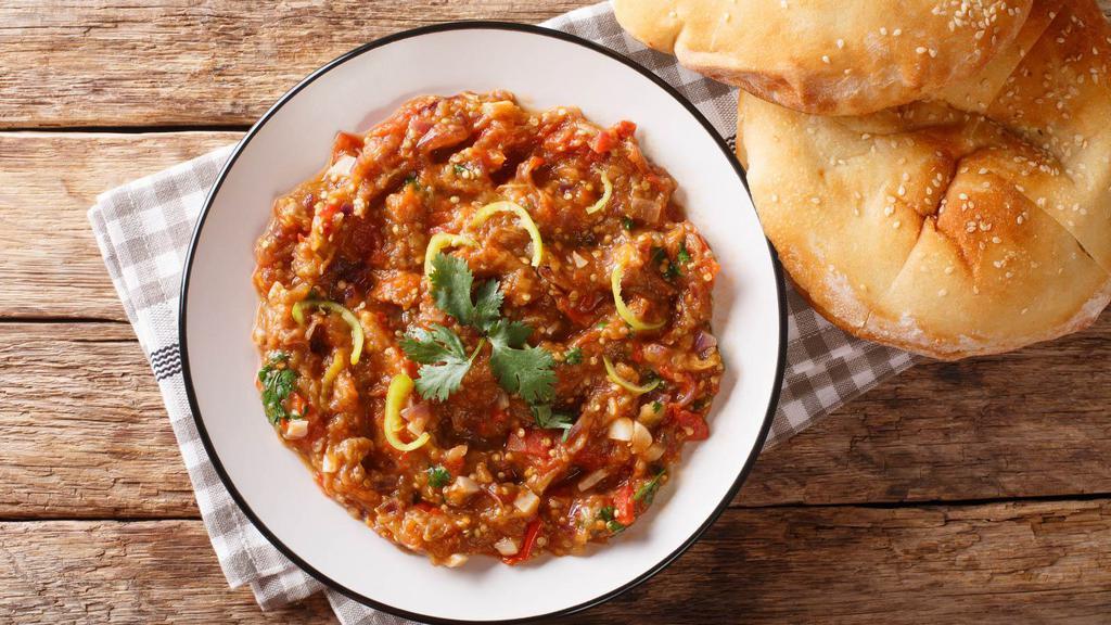 Baingan Bharta · Mashed eggplant cooked with onions, tomatoes & hot spices. Served with Basmati rice.