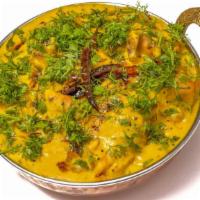 Punjabi Pakoda Kadhi · Spiced onion dumplings in tangy & spicy yogurt curry. Served with Basmati rice.