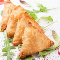 Samosa · Crisp turnovers filled with spiced potatoes & peas, served with tangy & spicy chutney.