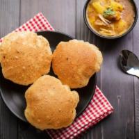 Poori Masala · Deep fried puffed bread served with mildly spiced mashed potatoes.