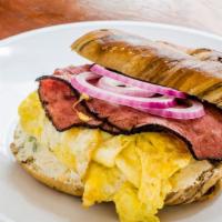 The Koch Sandwich · Hot grilled pastrami, 2 eggs, house-made scallion cream cheese, and diced red onion.