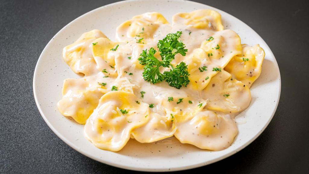 Cheese Ravioli · Freshly cooked ravioli with melted cheese.