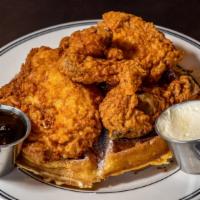 Chicken And Waffles Breakfast · Giant Belgian waffle and 4 pieces honey-dipped fried chicken, served with warm syrup and but...
