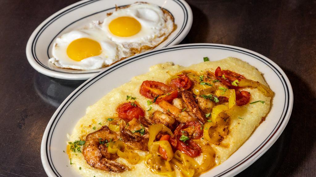 Breakfast Shrimp And Grits · Cajun shrimp and cheesy stone ground grits with tomato, spicy green peppers, herb butter and 2 eggs sunny side up.
