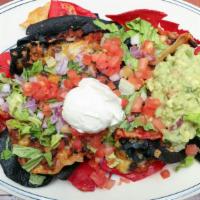 Ultimate Classic Nachos · Melted Cheddar Jack cheese, jalapeños, tomatoes, shredded lettuce and red onions and sour cr...