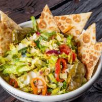 Jimmy K'S Greek Salad · Romaine lettuce, tomatoes, feta, cucumber, peppers, red onion, stuffed grape leaves, Kalamat...