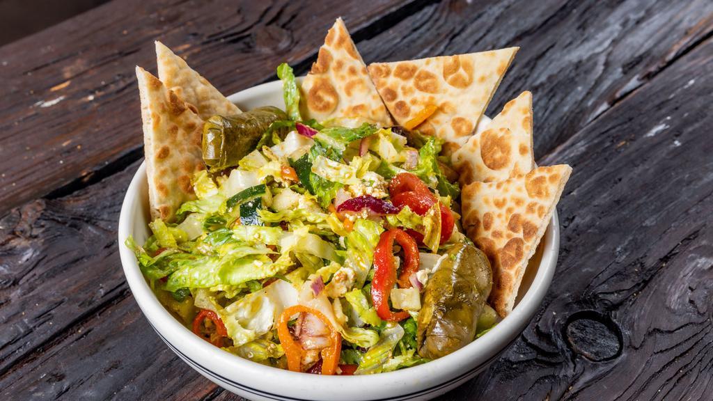 Jimmy K'S Greek Salad · Romaine lettuce, tomatoes, feta, cucumber, peppers, red onion, stuffed grape leaves, Kalamata olives, grilled pita and Greek dressing.