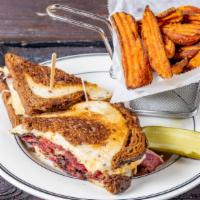 The Reuben Sandwich · House cured corned beef or pastrami, fresh sauerkraut, melted Swiss cheese and Russian dress...