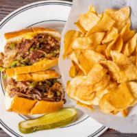 The Philly Cheesesteak Sandwich · Shaved rib-eye, sautéed onions, topped with choice of melted Swiss or melted American cheese...