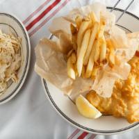 English Fish And Chips · Golden fried beer battered fresh cod, seasoned hand-cut French fries, and Creole slaw, serve...